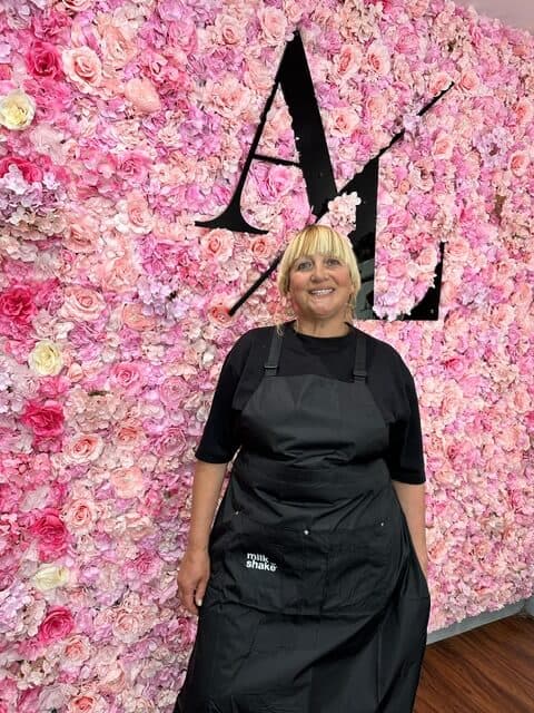 Iryna the hair stylist with a flower background